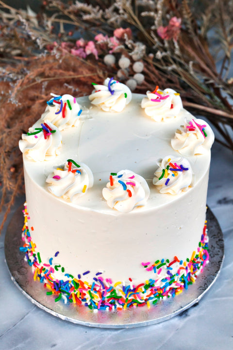 A cake with multi-coloured sprinkles